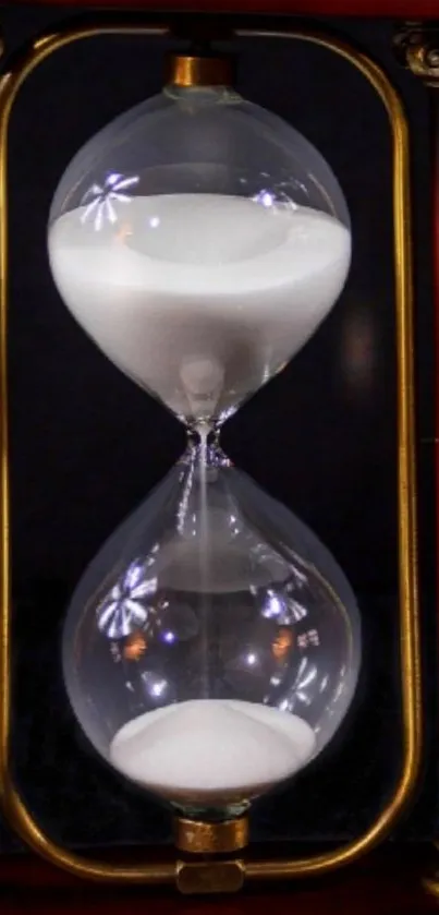 Elegant vintage hourglass against dark background.