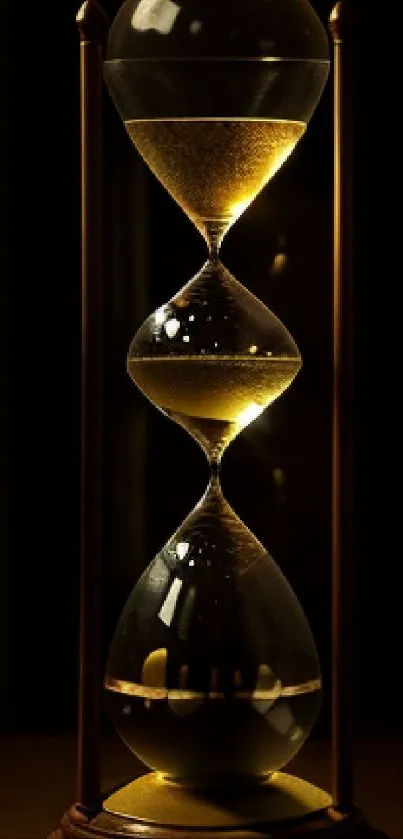 Elegant hourglass with golden hues on black background.