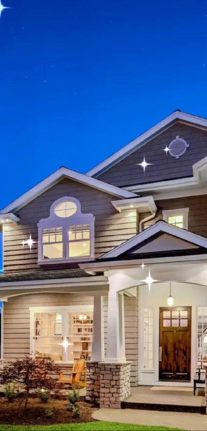 Elegant house at dusk with lit windows and a blue sky.