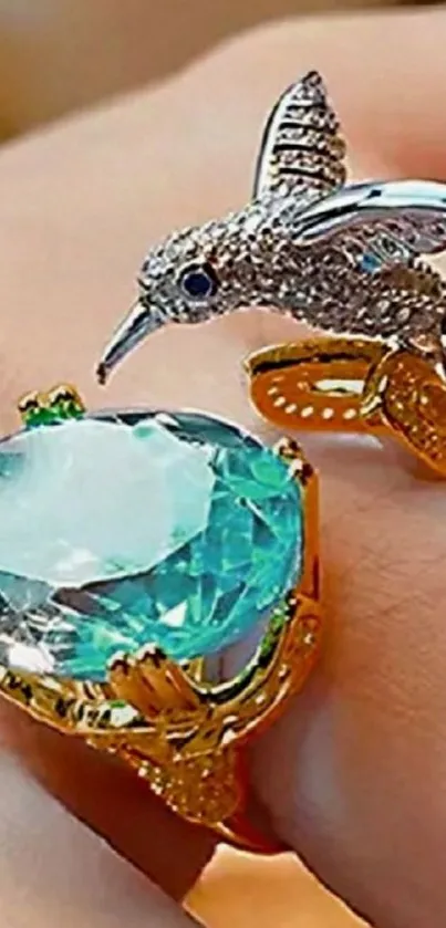 Hummingbird and gemstone ring on finger.