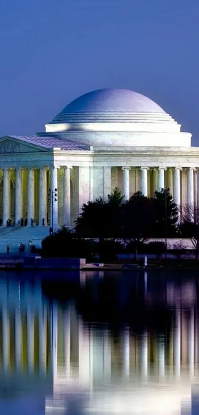 Jefferson Memorial at night with reflection in water.