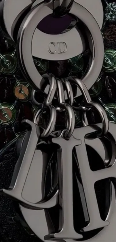 Elegant keychain with metallic letters and intricate design.