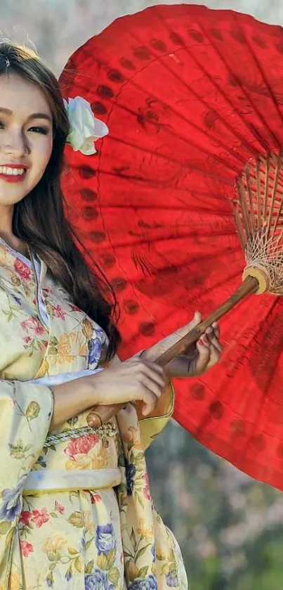 Woman in floral kimono with red parasol outdoors.