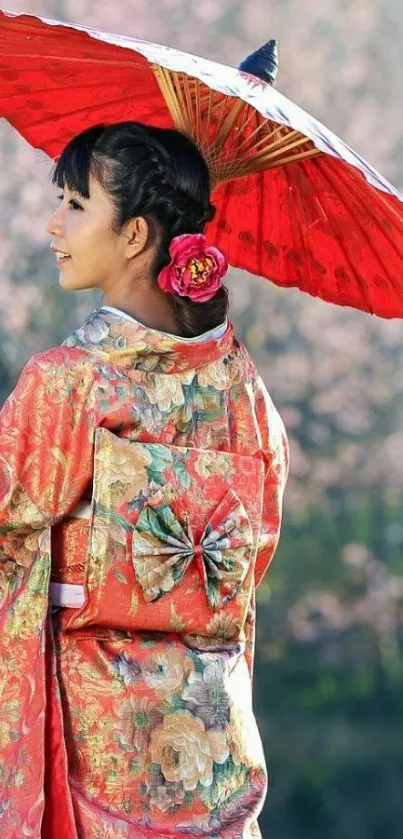 Woman in floral kimono with red umbrella in nature.