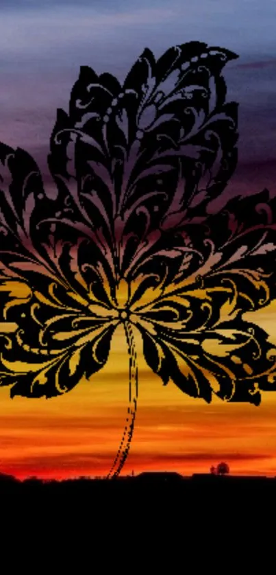 Black leaf silhouette over orange sunset gradient background.