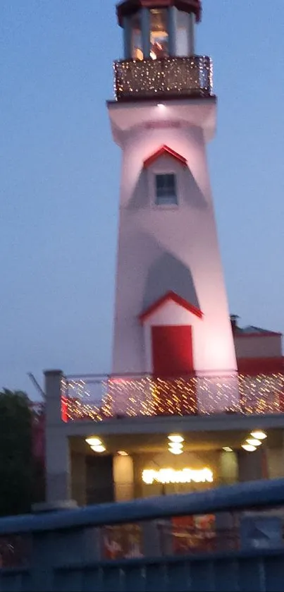 Lighthouse at dusk with soft blue sky and elegant lighting.