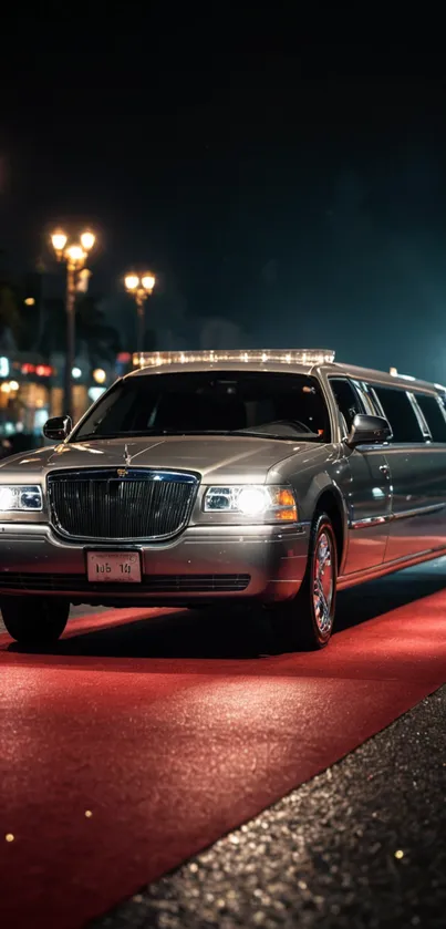 Luxury limousine on red carpet at night with street lights.