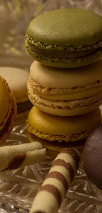 Stack of elegant macarons in various colors on a glass platter.