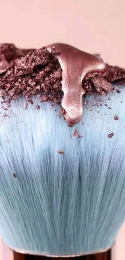 Elegant makeup brush with pastel blue bristles and shimmering pigment.