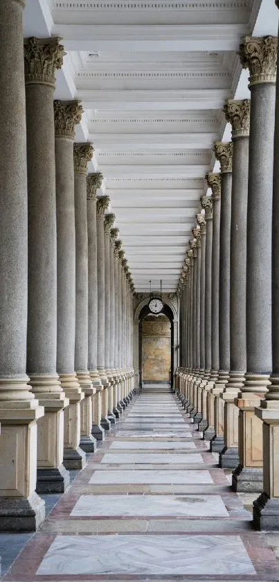 Marble pillar corridor with ornate ceiling and symmetrical design.