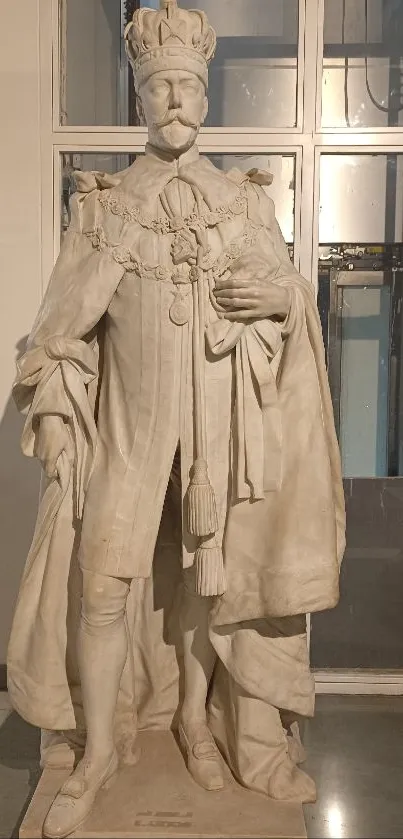 Marble statue of a regal figure in a museum setting.