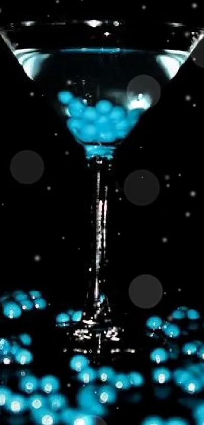 A martini glass with blue glowing orbs on a dark background.