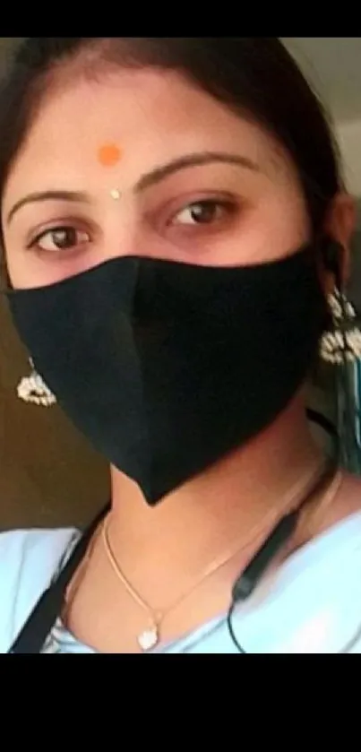 Woman with black mask and earrings for mobile wallpaper