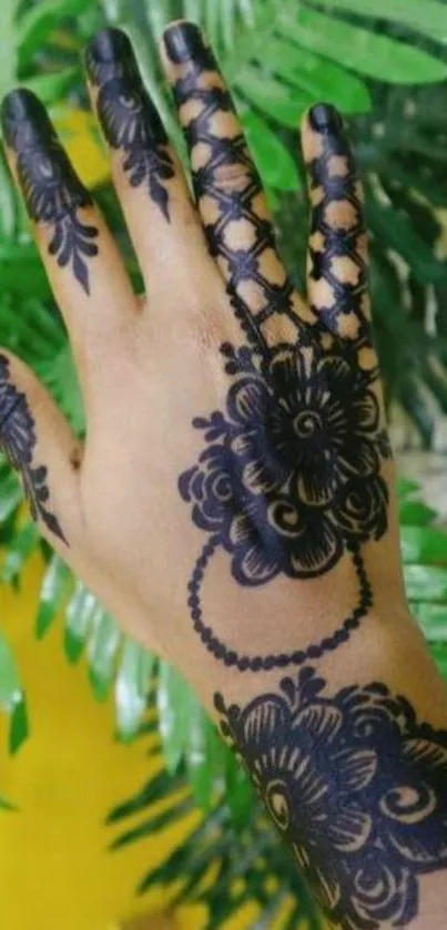 Beautiful mehndi design on hand with green leaves background.