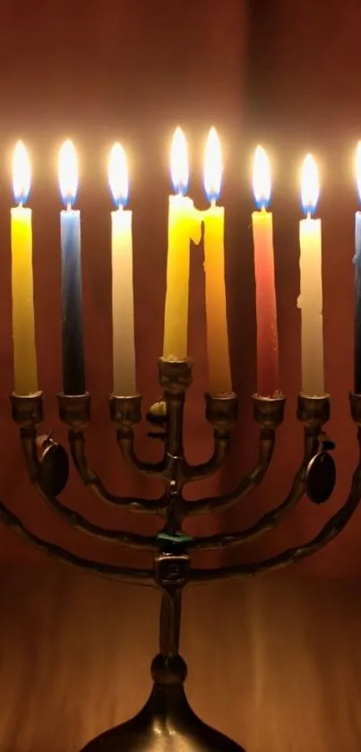 Lit menorah with colorful candles on display.