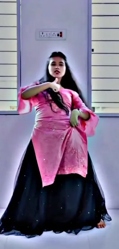 Elegant modern dance pose in pink and black attire.