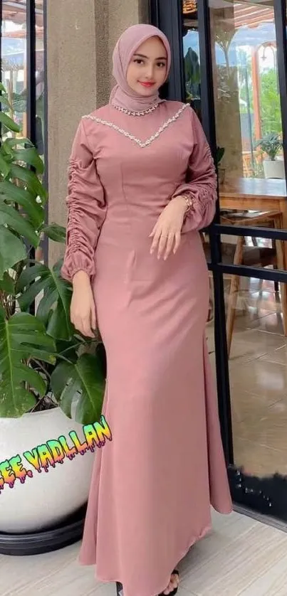 Elegant woman in dusty rose hijab and dress.