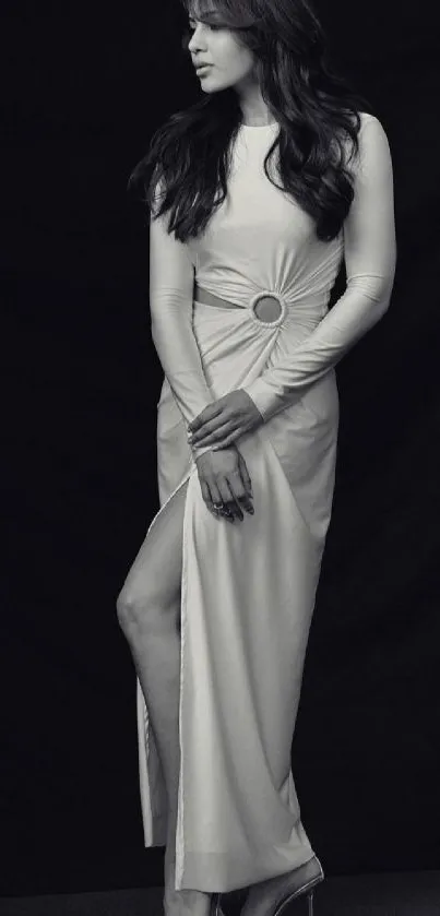 Black and white portrait of a woman in a long, elegant dress.