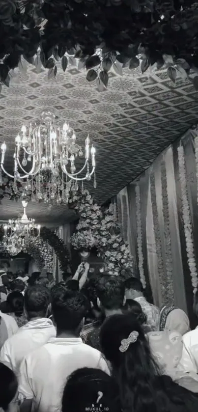 Monochrome wedding scene under chandeliers with elegant décor.