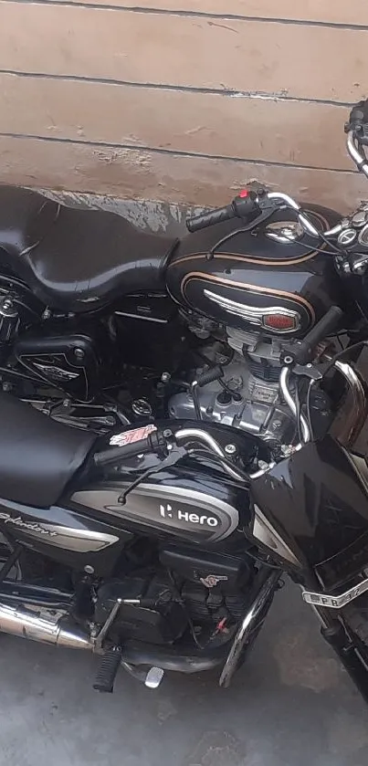 Top view of two parked black motorcycles on a concrete floor.