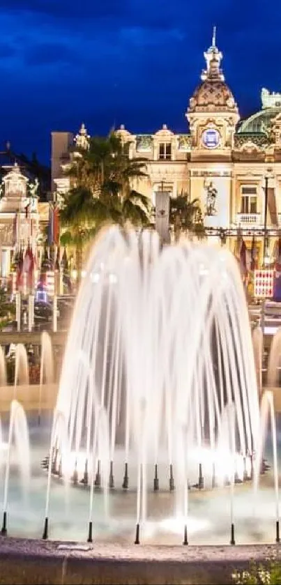 Nighttime view of a grand fountain with illuminated architecture.