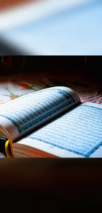 Open book with blue tinted pages and warm lighting on a table.