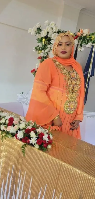 Woman in orange attire with floral decorations.