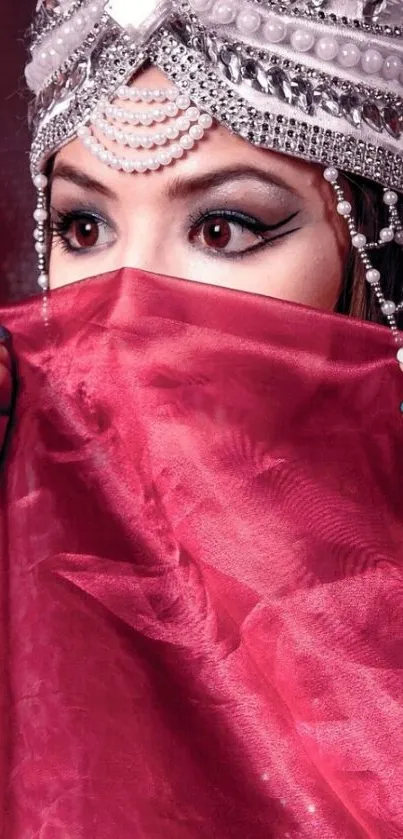 Woman with jeweled headpiece and red veil.