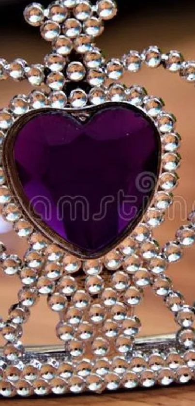 Ornate tiara with purple gemstones on a wooden background.