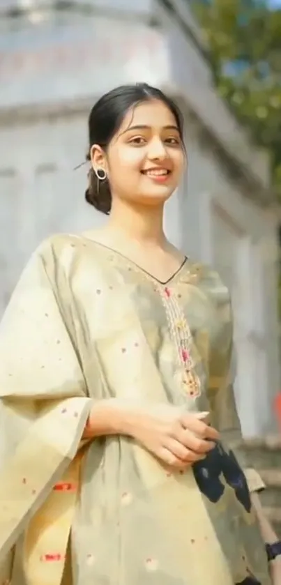 Portrait of a woman in a beige traditional outfit outdoors.