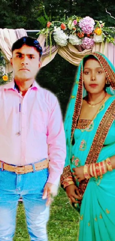 Elegant couple in traditional attire posing at outdoor wedding with floral arch.