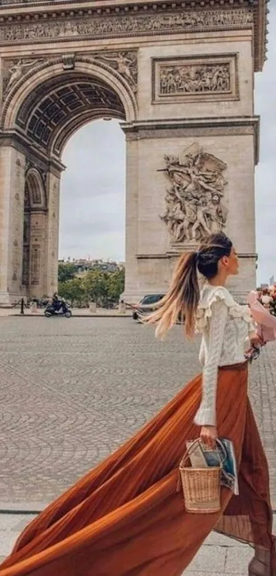 Woman in flowing skirt near Arc de Triomphe in Paris.