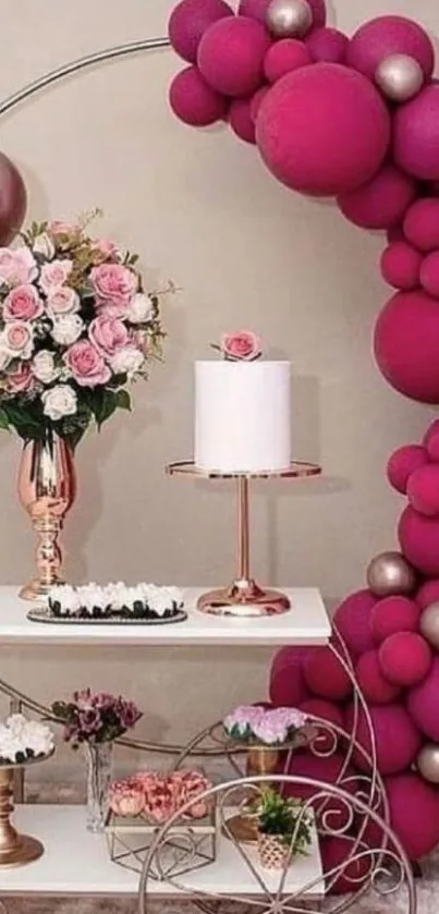 Elegant party setup with pink balloons and flowers.