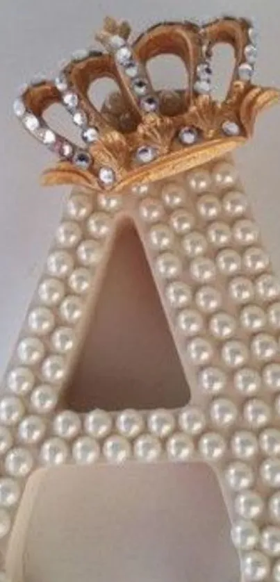 Pearl studded letter A with a golden crown.