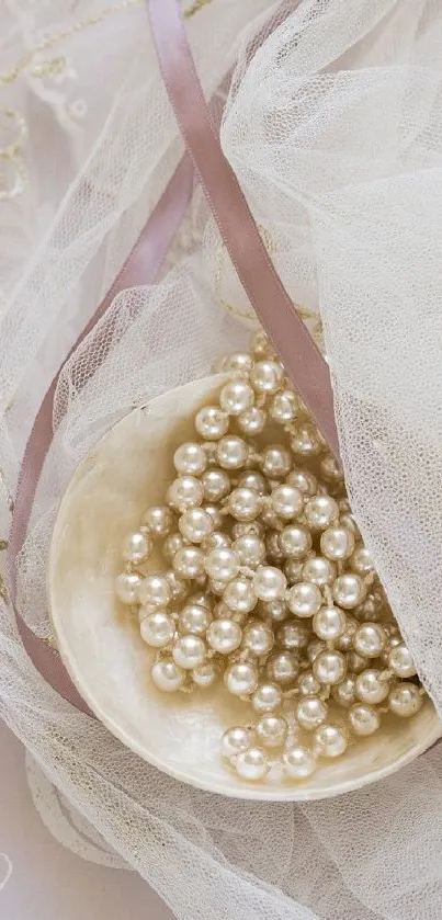 Elegant pearls resting on delicate lace with ribbon.