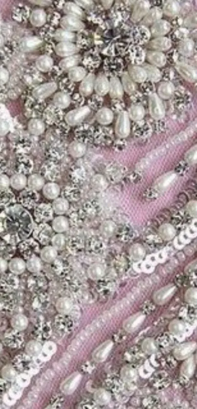 Intricate pearl beadwork on pink fabric wallpaper.