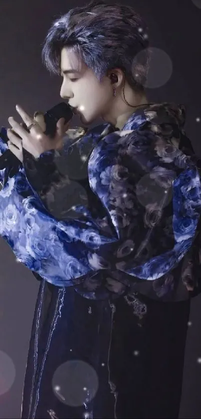 Performer in blue floral robe with focused expression.