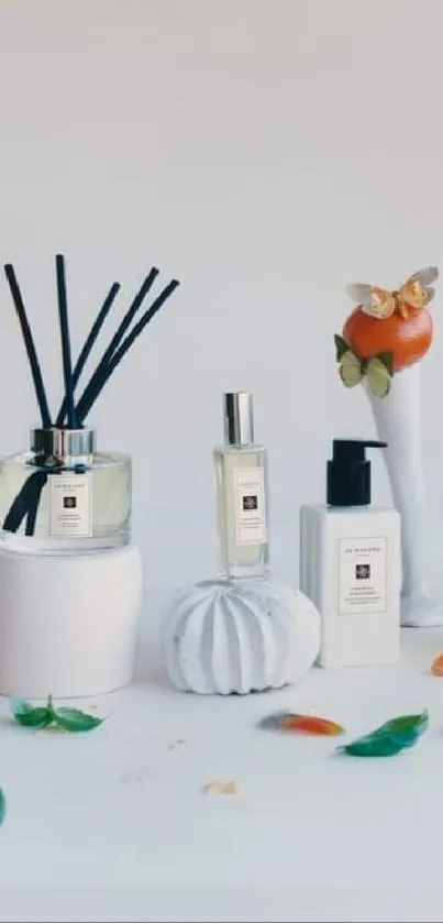 Elegant perfume bottles and citrus fruits displayed on a white surface.