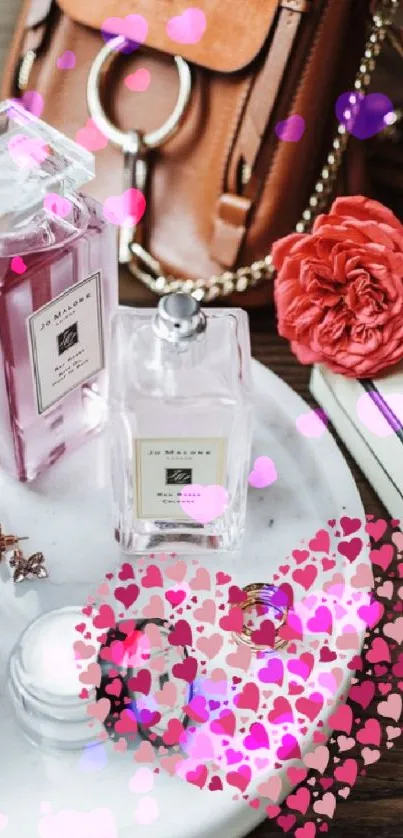 Elegant arrangement of perfumes, handbag, and flowers on a decorative tray.
