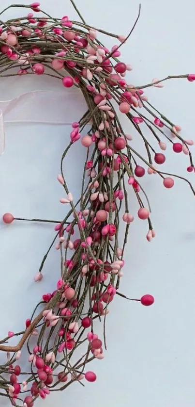 Pink berry wreath on a light background.