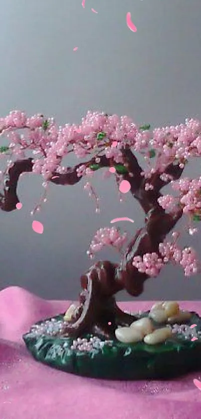 Pink blossom bonsai tree on a soft pink surface.