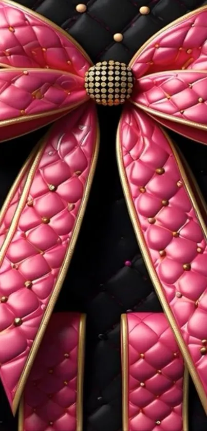 Luxurious pink bow with quilted texture and golden accents on a black background.