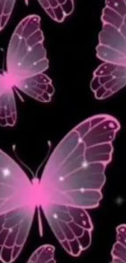 Pink glowing butterflies on a dark background wallpaper.
