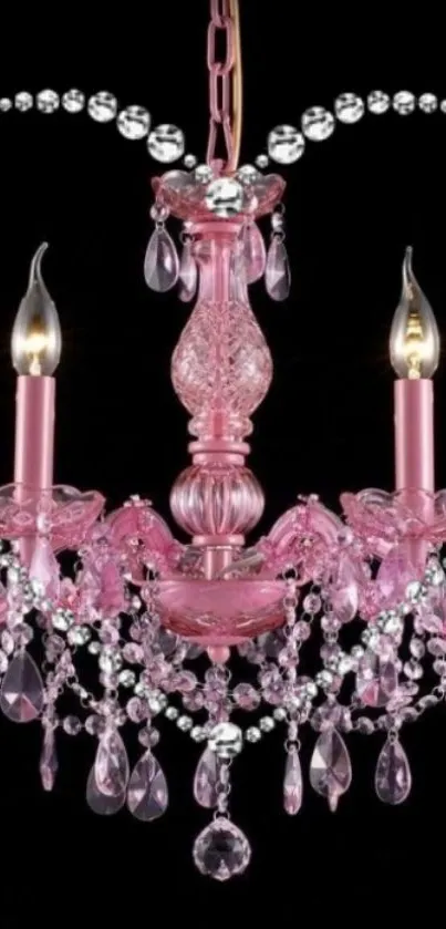 Elegant pink chandelier with crystals on black background.