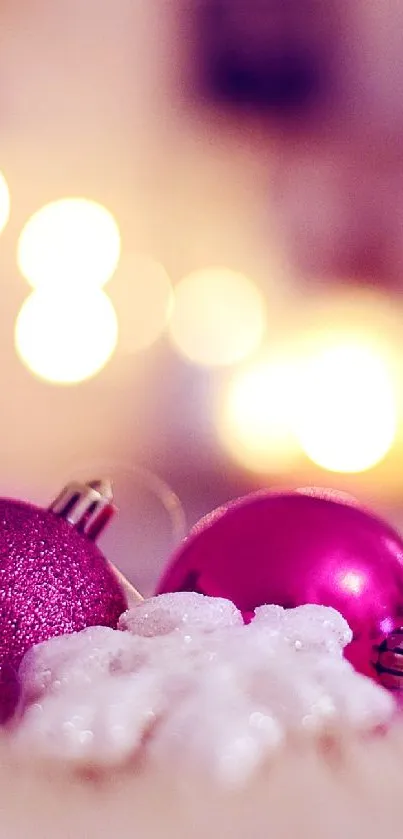 Elegant pink Christmas ornaments on a soft, blurred background.