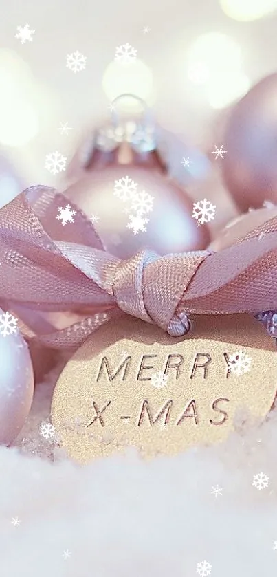 Light pink Christmas ornaments on snow with a warm glow.