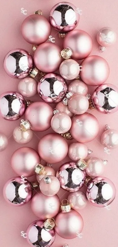 Pink Christmas ornaments on a pastel background.