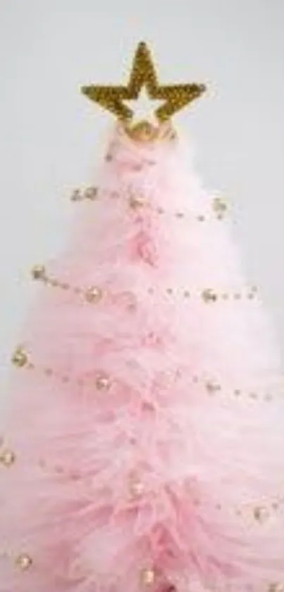 Pink Christmas tree with golden star and ornaments on white background.