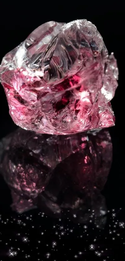 Shimmering pink crystal on reflective black background.