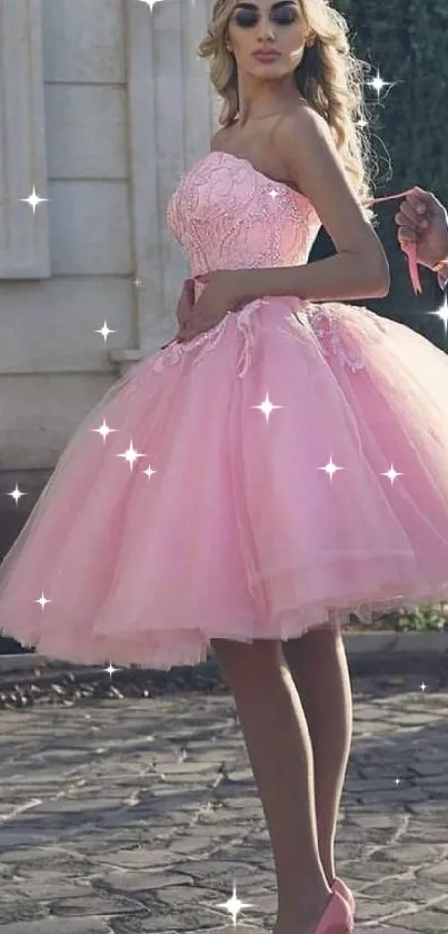 Woman in an elegant pink dress posing outdoors.